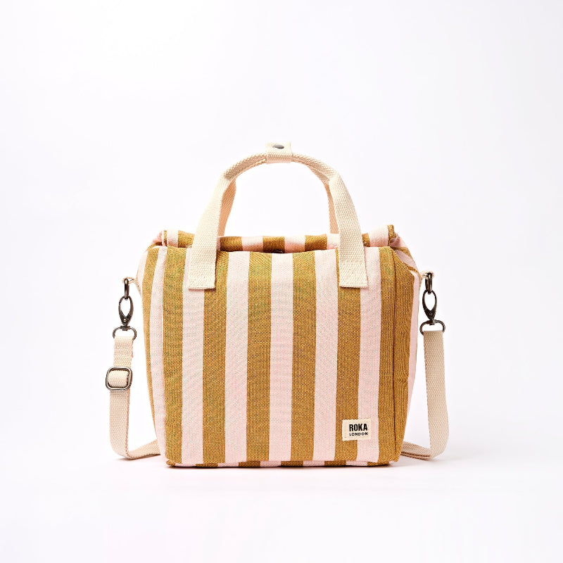Striped handbag with beige and pink stripes on a white background