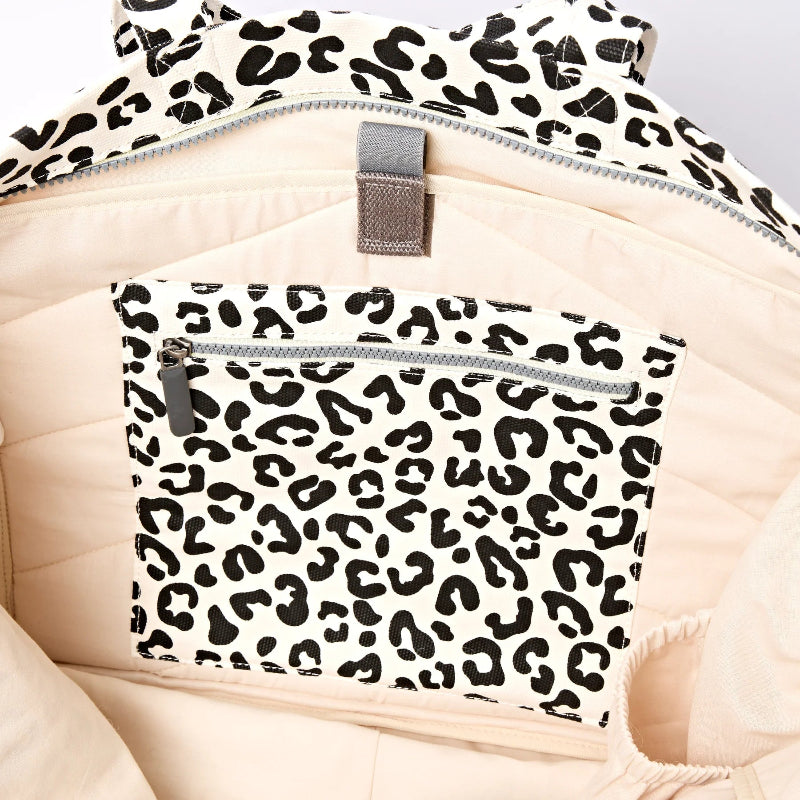Leopard print Roka Marylebone large tote bag with zippers on a beige background