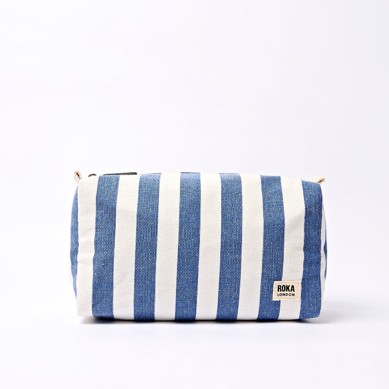 Blue and white striped pouch with Roka London branding on a white background