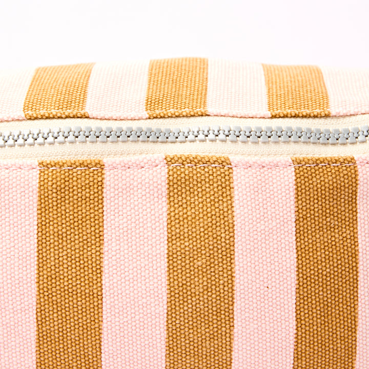 Close-up of a striped pouch with yellow and pink horizontal stripes on a white background