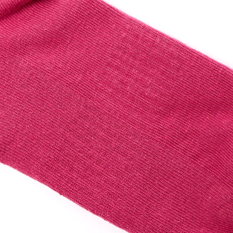 Close-up of a pink sock with a textured surface on a white background
