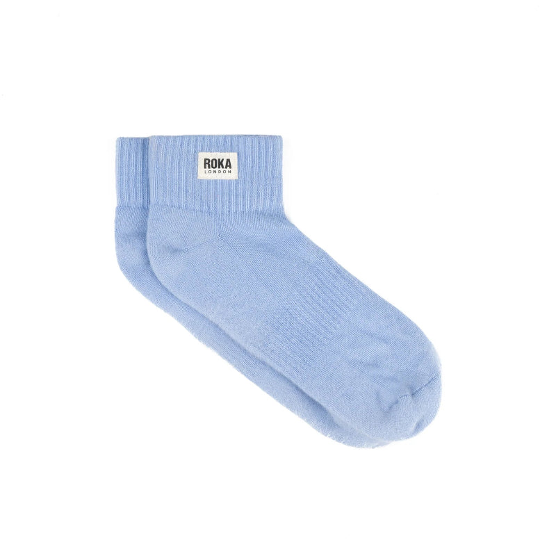 Light blue sock with Roka London label on a white background