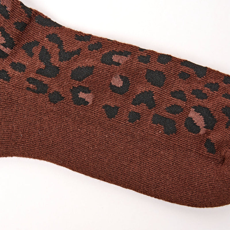 Brown sock with black leopard print pattern on a white background