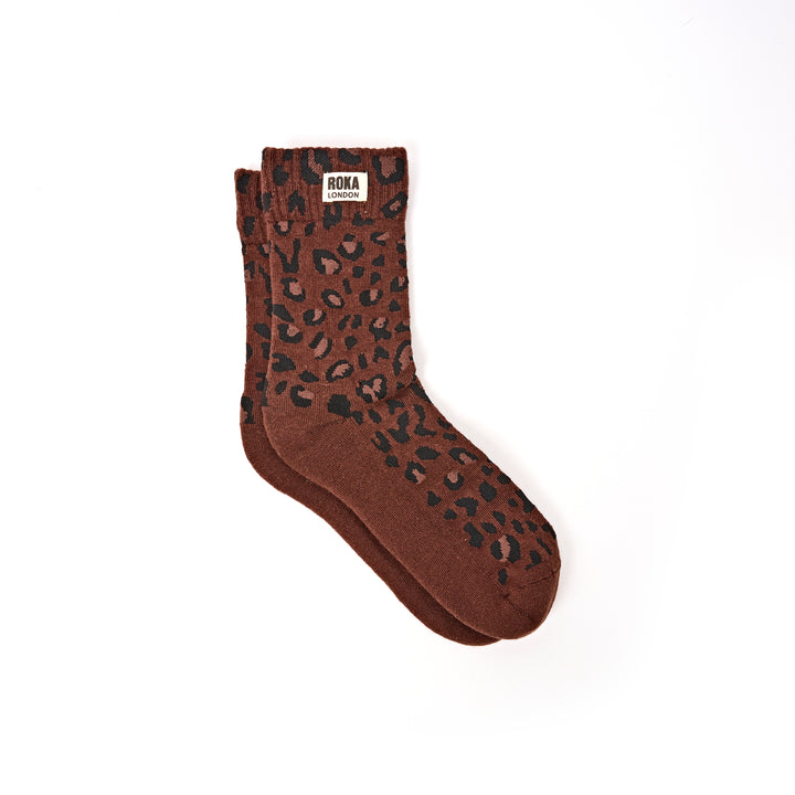 Brown sock with leopard print pattern on a white background