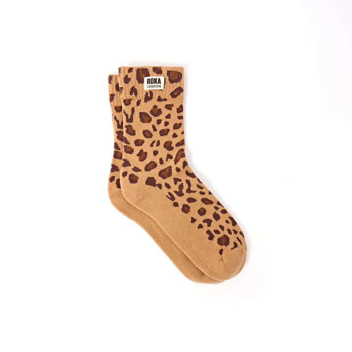 Tan sock with brown leopard print pattern on a white background