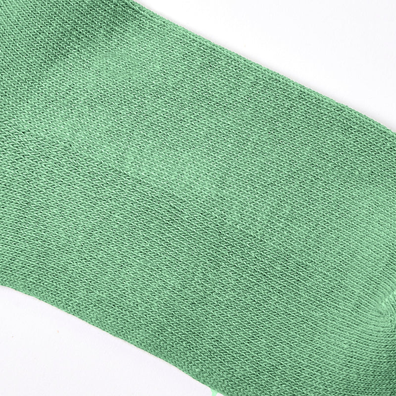 Close-up of a green sock on a white background