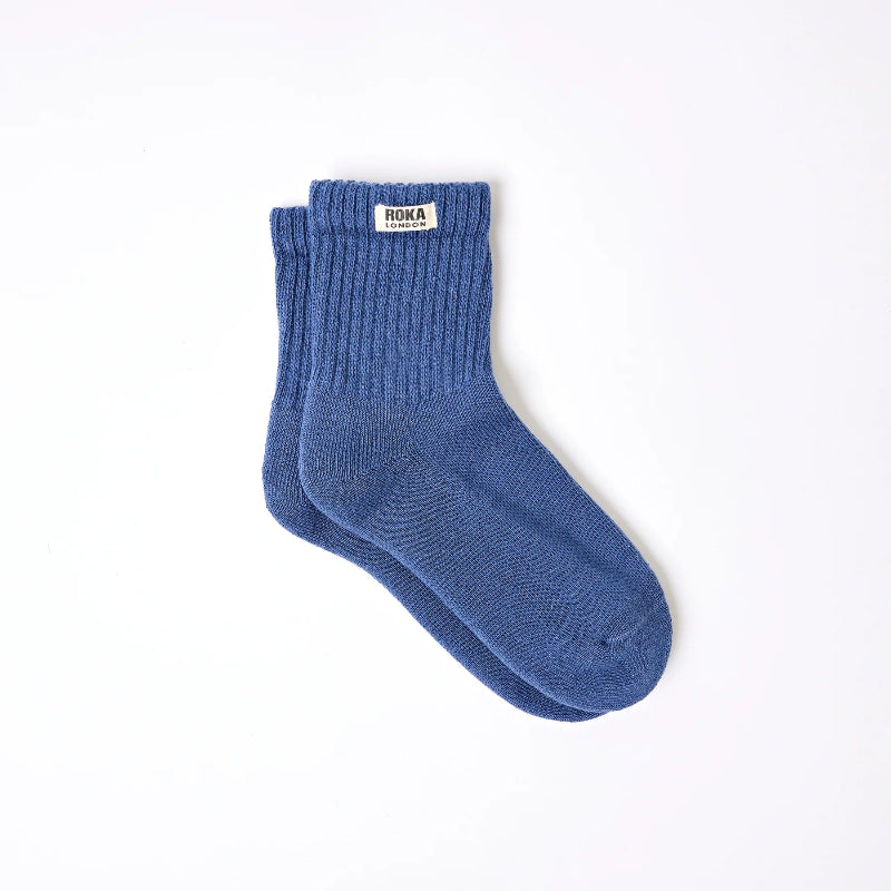 Blue sock with a brand label on a white background