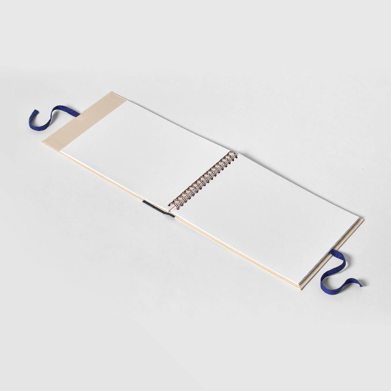 Open notebook with a blue pen holder on a white background