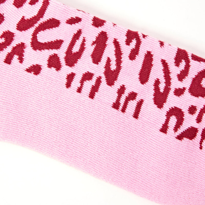 Close-up of pink fabric with red leopard print pattern
