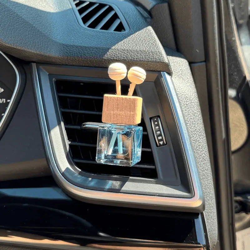 Car air freshener shaped with reeds in a car's air vent.