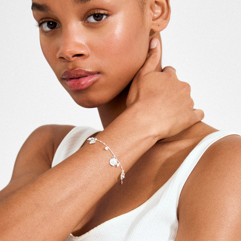 Woman wearing a silver bracelet on a white background