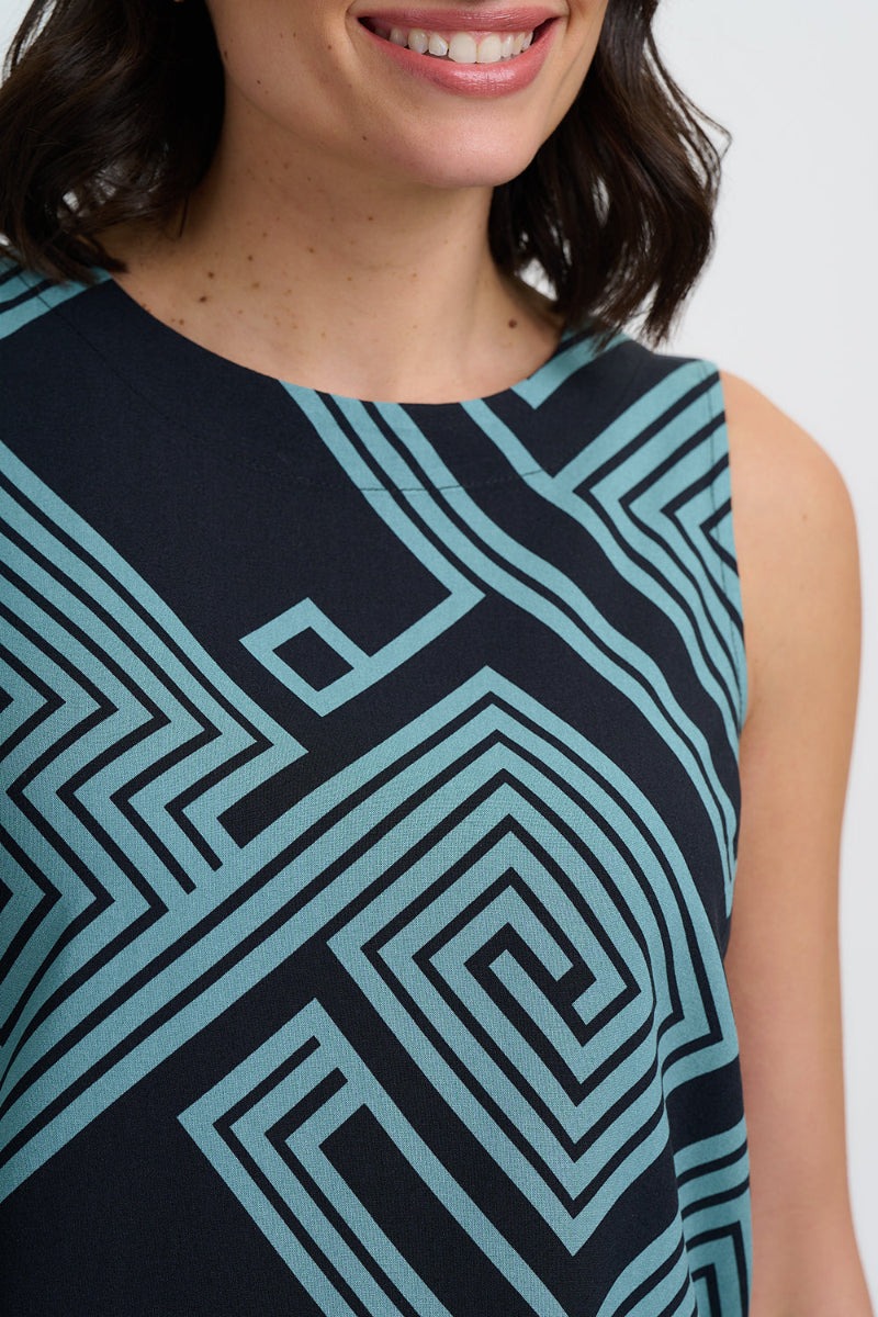 Woman wearing a sleeveless dress with geometric pattern on a white background
