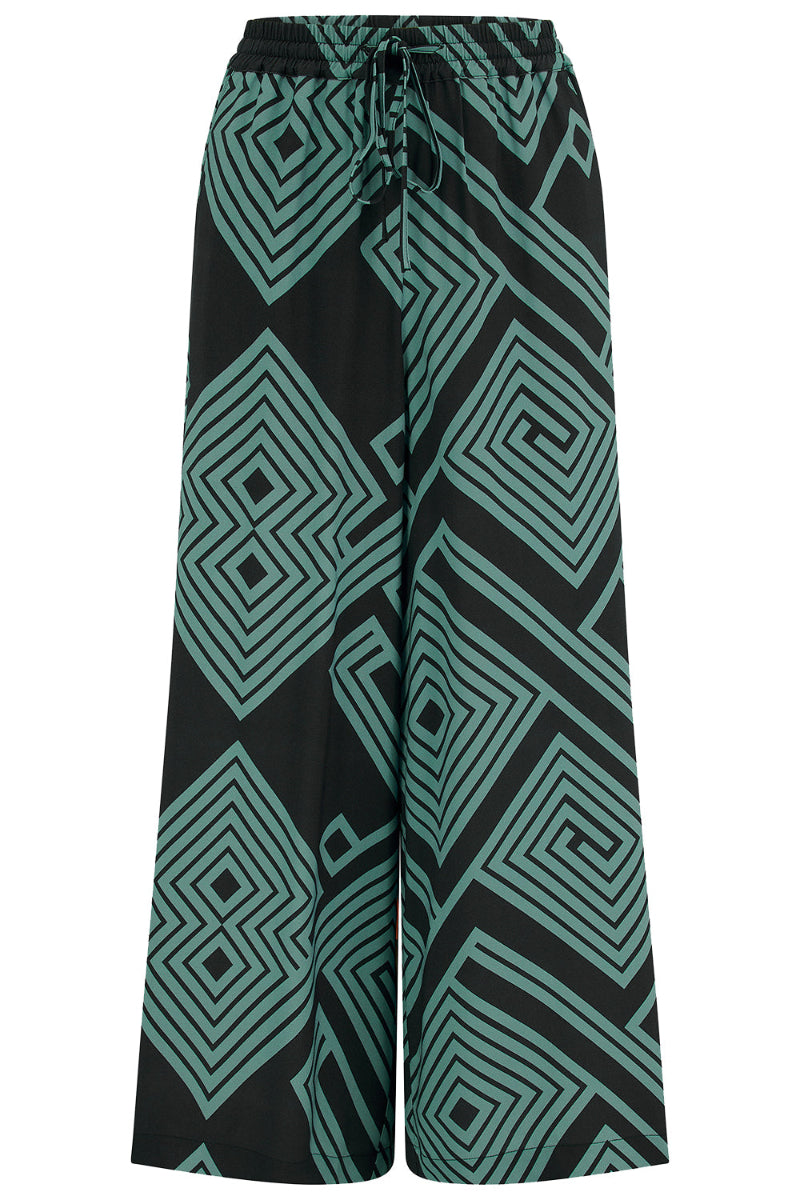 Black pants with green geometric pattern on a white background
