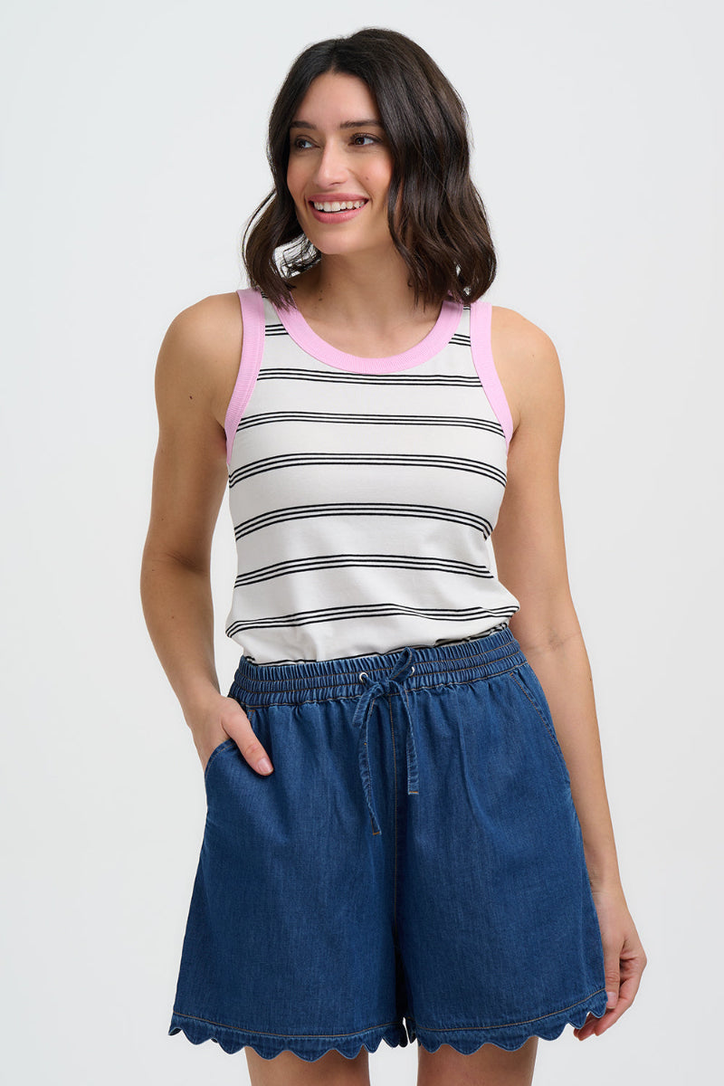 Woman wearing a striped tank top and denim shorts on a white background