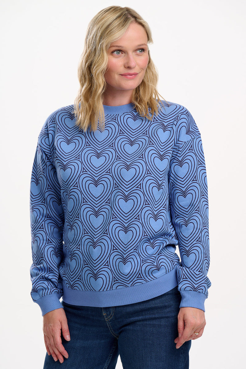 Woman wearing Sugarhill  Blue Heart Explosion Sweatshirt  white background
