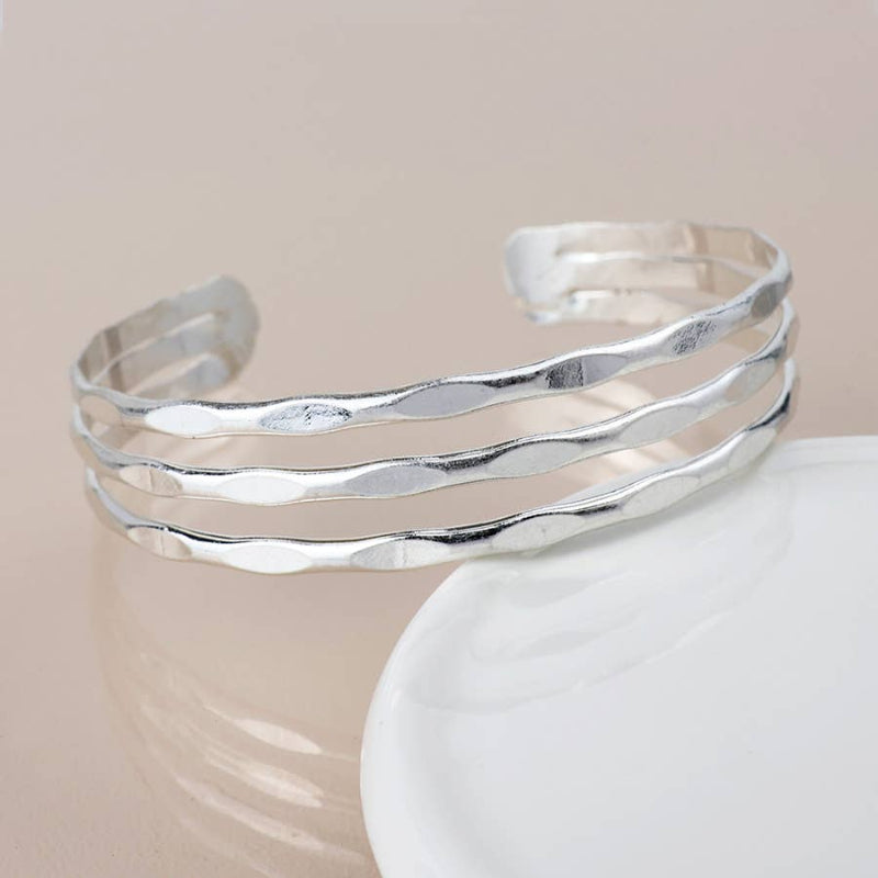 Silver bracelet on a beige background