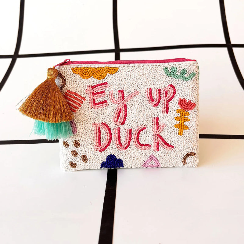 Beaded pouch with colorful text and tassel on a white background