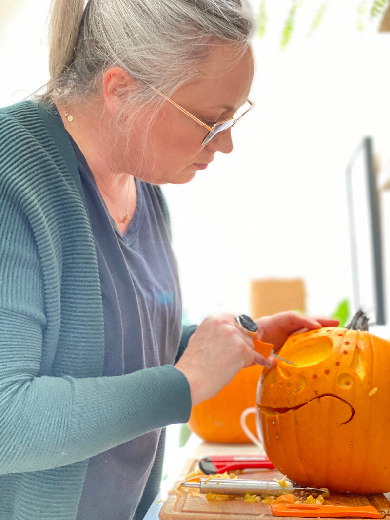 Alison carving a pumpkin for halloween