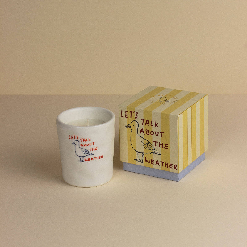 Candle with 'Let's Talk About the Weather' text and a matching striped box on a beige background