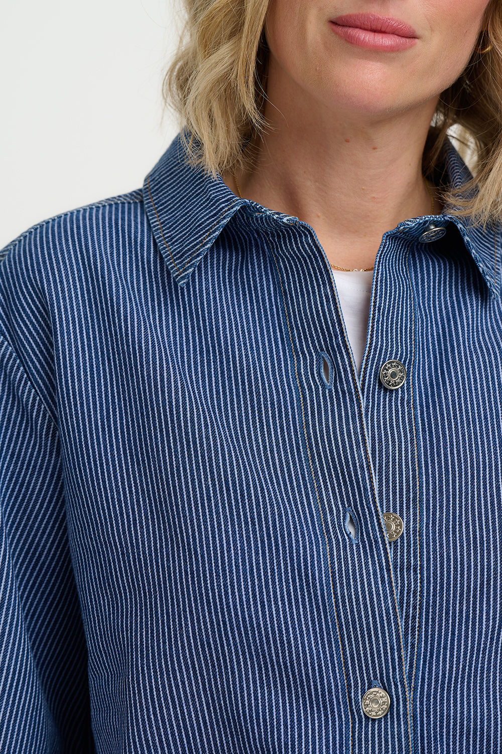 Close-up of a person wearing Sugarhill Amity Jacket-Blue Stripe Denim with a neutral background