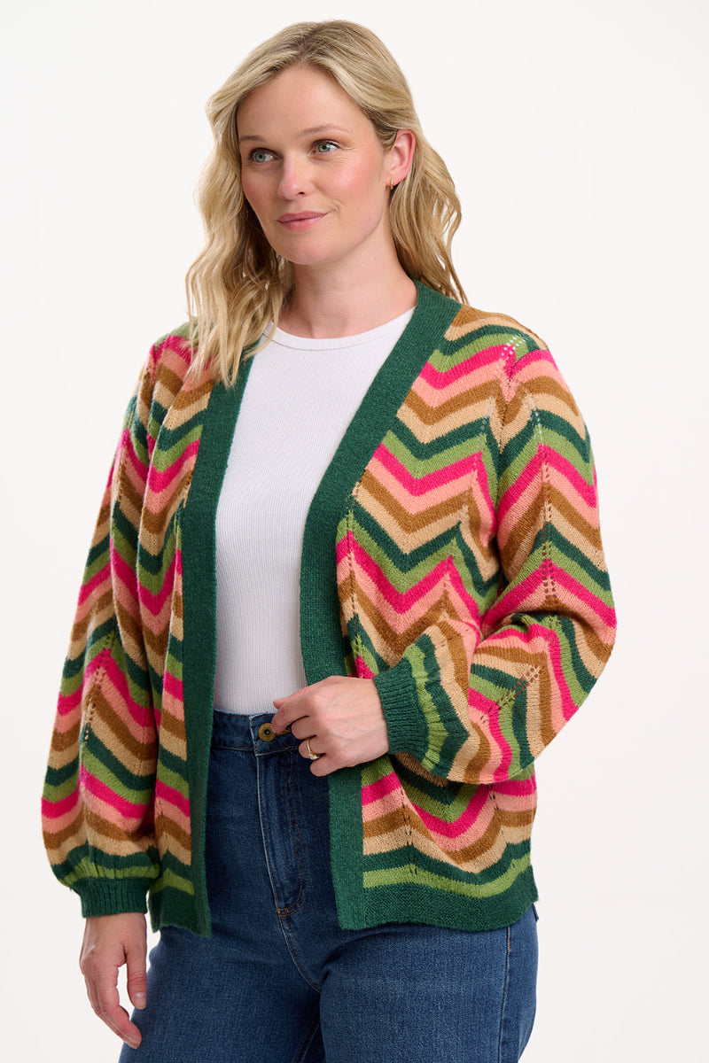 Woman wearing Sugarhill Bella Cardigan colorful striped cardigan on a white background
