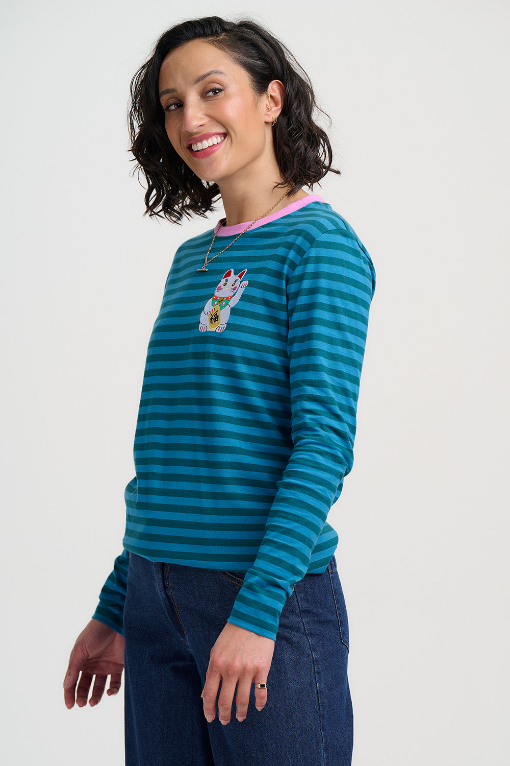 Woman wearing a Sugarhill Brighton Brunswick Lucky Cat Jersey Top on a white background
