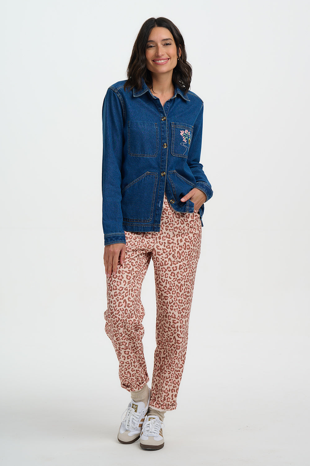 Woman wearing a Sugarhill Dita Denim Jacketand leopard print pants on a white background
