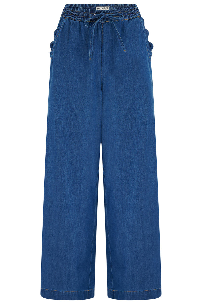 Blue denim pants with a drawstring waist on a white background