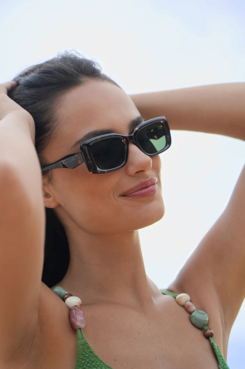 Woman wearing sunglasses with a blurred background