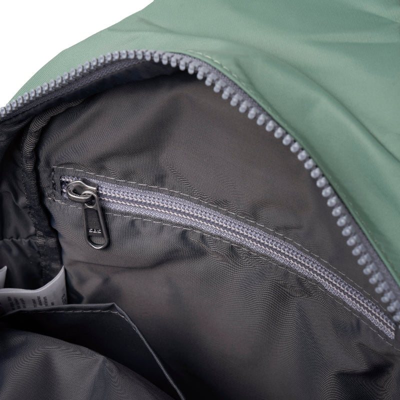 Close-up of a zipper on a green and black jacket