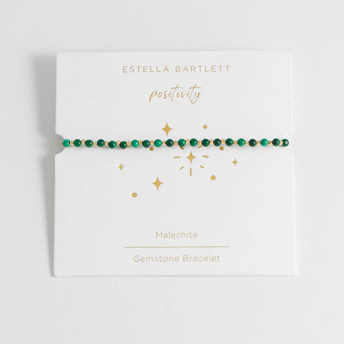 Bracelet on a branded card with 'Estella Bartlett' and 'positivity' text.