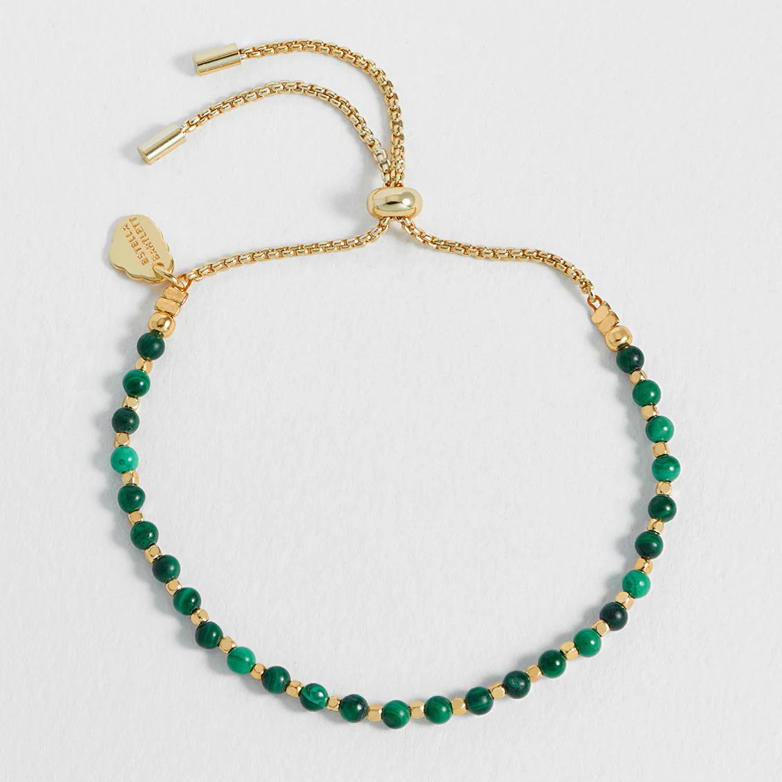 Estella Bartlett Malachite Gemstone Bracelet - Positivity - Gold bracelet with green beads on a light gray background