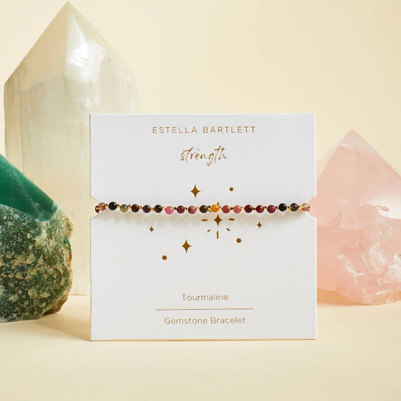 Estella Bartlett gemstone bracelet on a branded card with crystals in the background