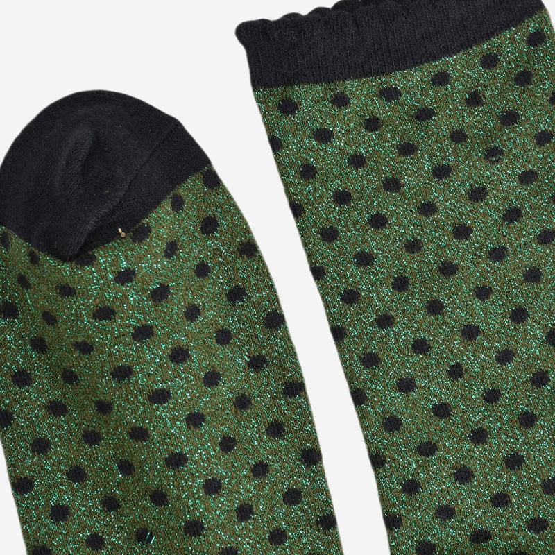 Green socks with black polka dots on a white background