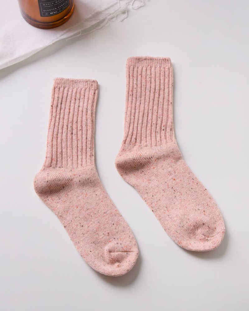 Pair of pink socks on a light gray background