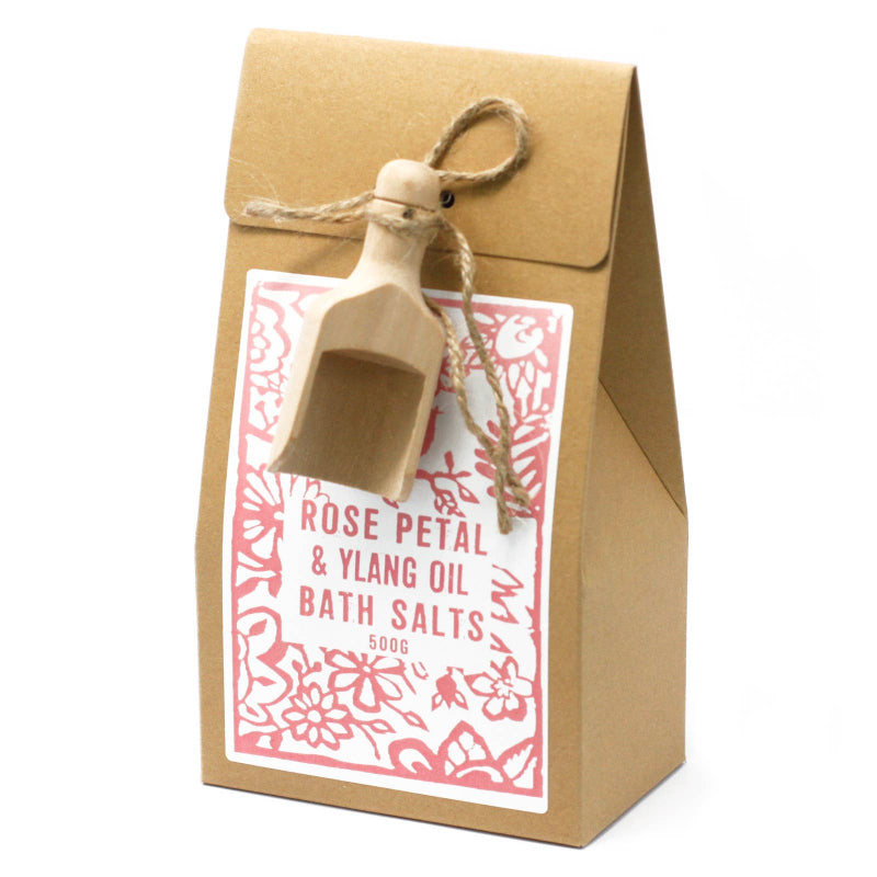 Kraft paper packaging of rose petal and ylang oil bath salts with a decorative tag.