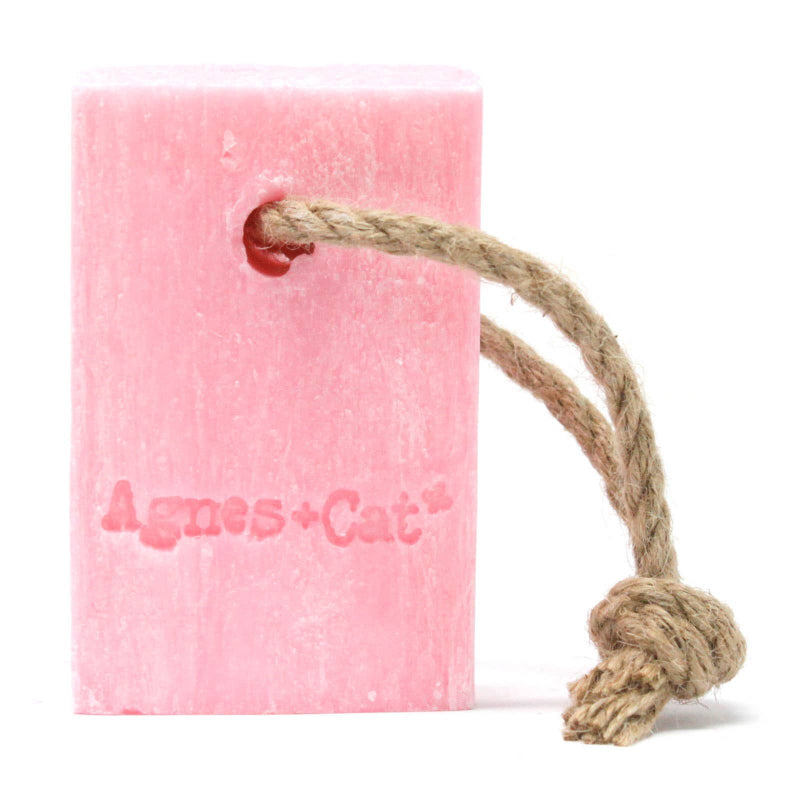 Pink catnip toy with a rope on a white background
