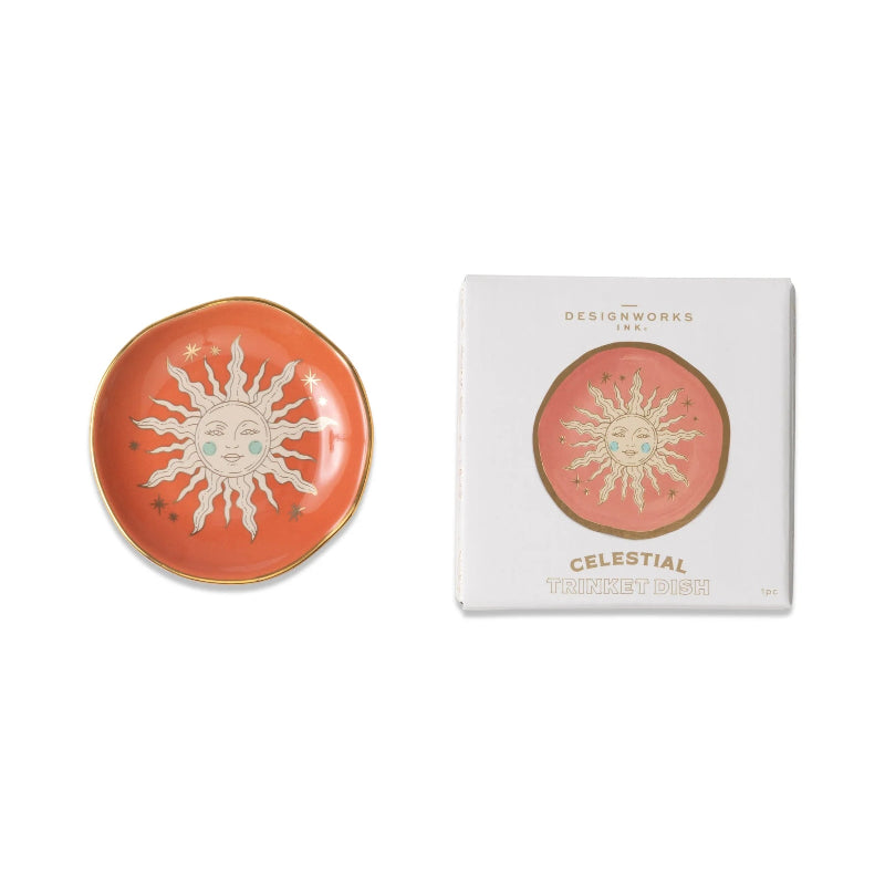Decorative dish with celestial design next to its packaging on a white background