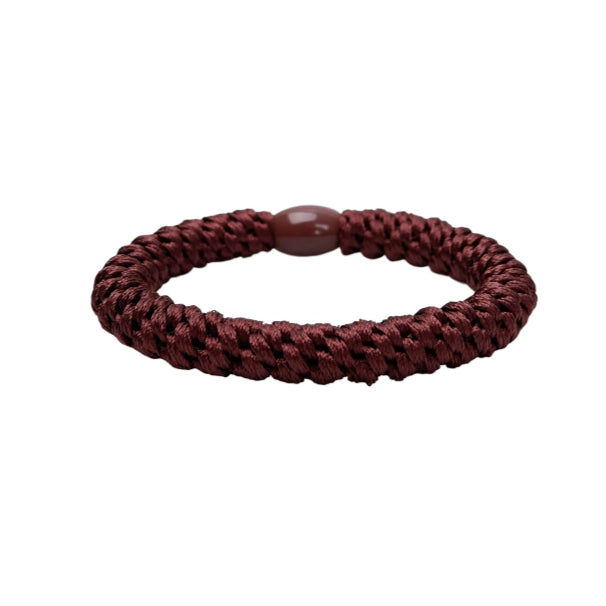 Brown braided hair tie on a white background