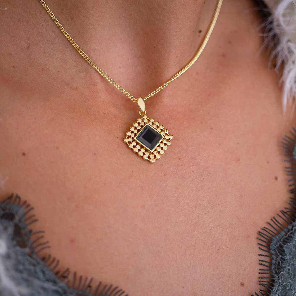 gold necklace with black onyx diamond shape pendant