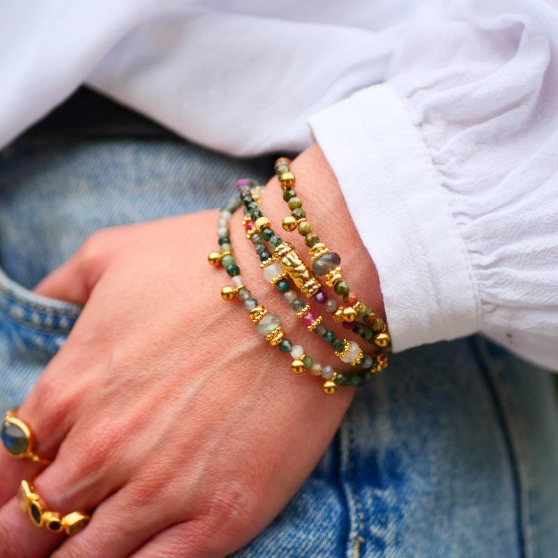 boho bracelets stacked with gold charms