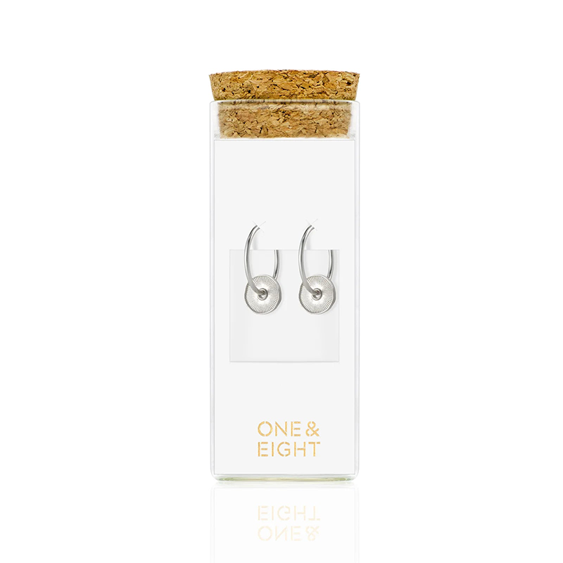 one & eight sorrel earrings in a glass bottle
