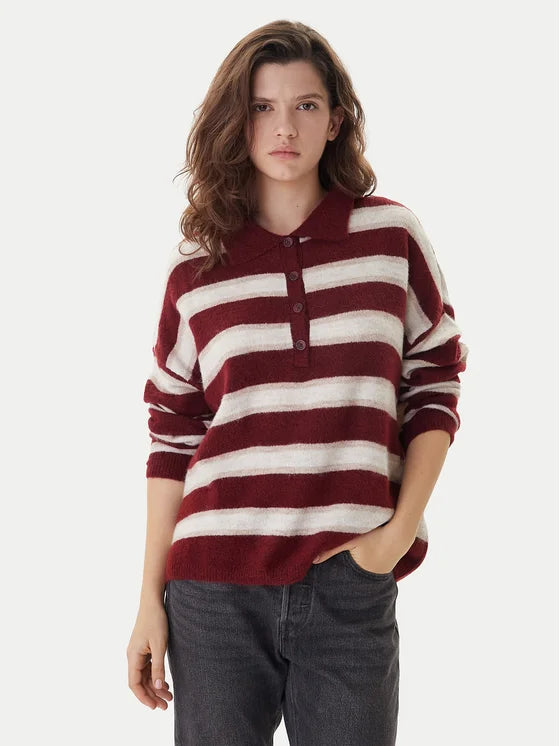 Woman wearing a red and white striped sweater on a white background
