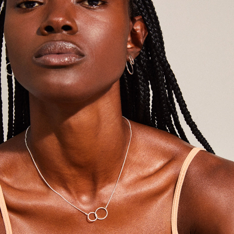 Woman wearing a Pilgrim Harper Necklace Silver-plated with a plain background