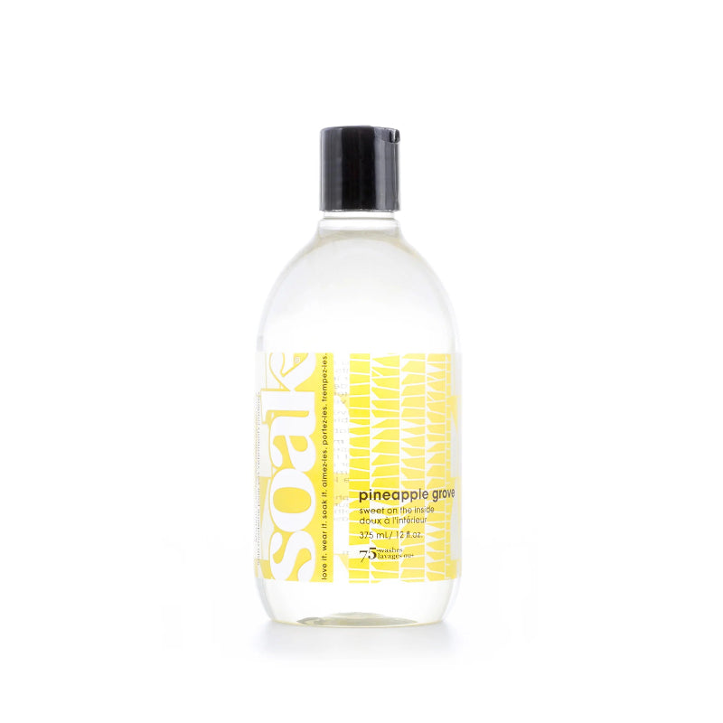 Bottle of Suave hair product with yellow label on a white background