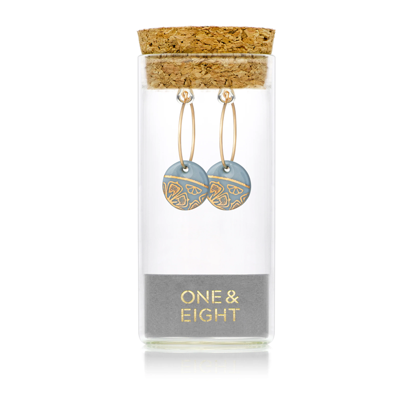 one and eight earrings in glass tube and cork lid