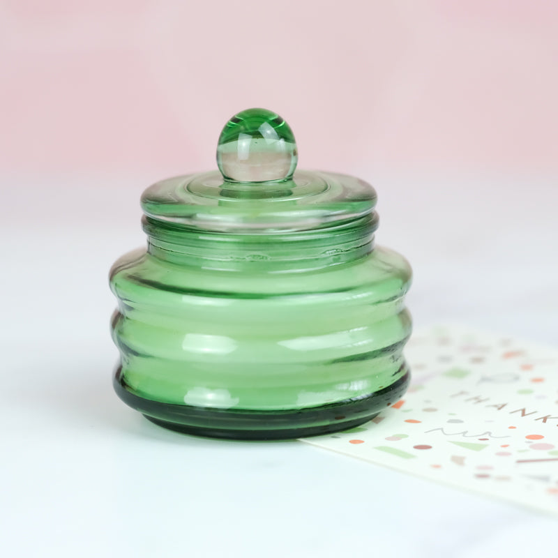 cactus flower scented soy candle in green glass jar