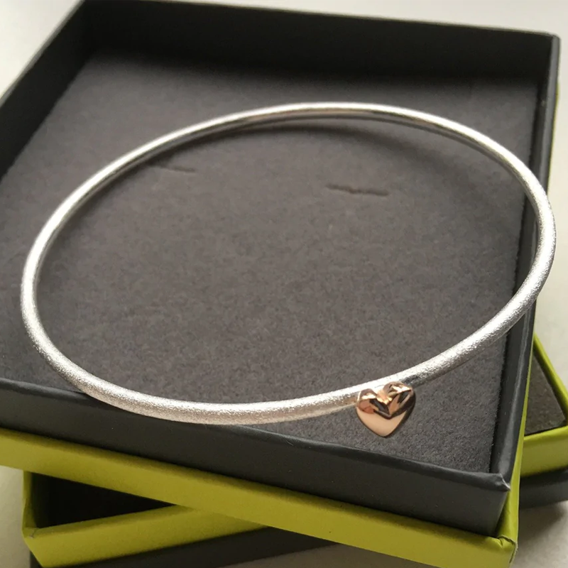 gold heart on a silver bangle
