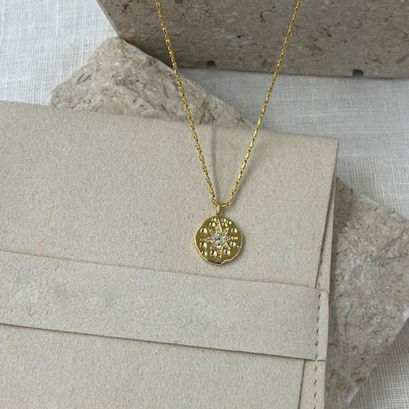 gold necklace with star imprint and cz stones